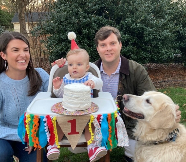 Family celebrating babies first birthday.